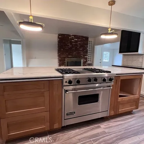 a stove top oven sitting inside of a kitchen