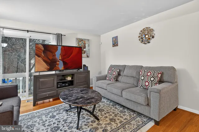 a living room with furniture and a rug