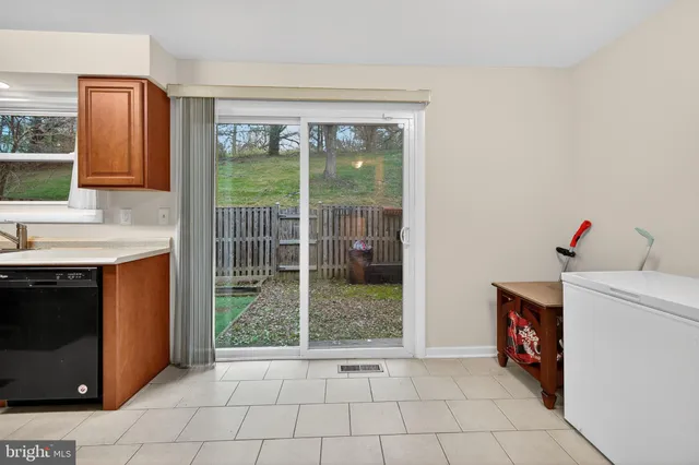 a view of an empty room with a fireplace and a window