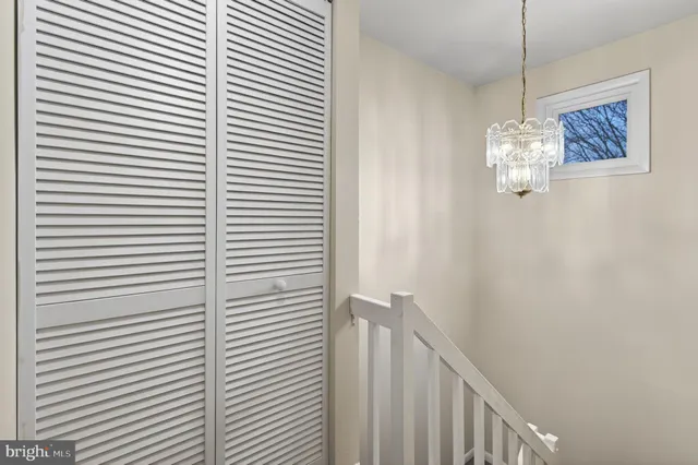 a bedroom with a bed and a mirror on dresser