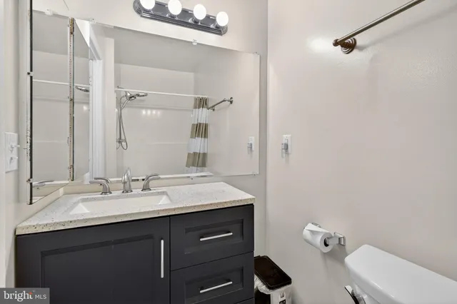 a bedroom with a bed a chandelier and closet