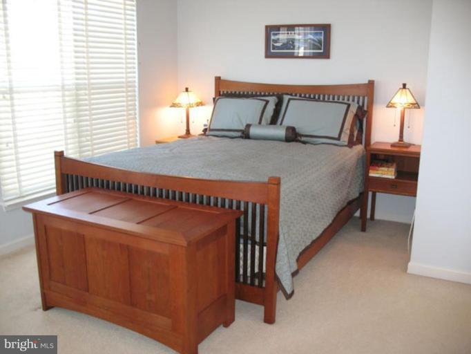 5866 Summers Grove Road Alexandria, VA 22304 - Photo 13 of 19 a bed sitting in a bedroom next to a window