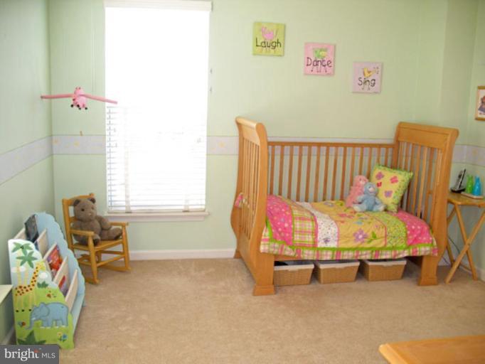 5866 Summers Grove Road Alexandria, VA 22304 - Photo 18 of 19 a bed room with a bed and a chair