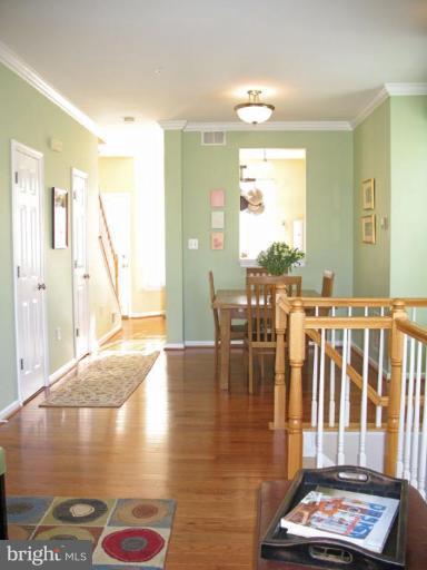5866 Summers Grove Road Alexandria, VA 22304 - Photo 7 of 19 a view of dining room and hall with wooden floor