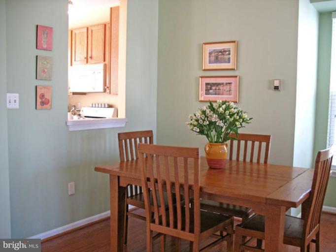 5866 Summers Grove Road Alexandria, VA 22304 - Photo 9 of 19 a view of a dining room with furniture window and wooden floor