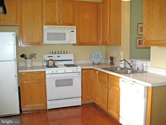5866 Summers Grove Road Alexandria, VA 22304 - Photo 10 of 19 a kitchen with a stove top oven sink and cabinets