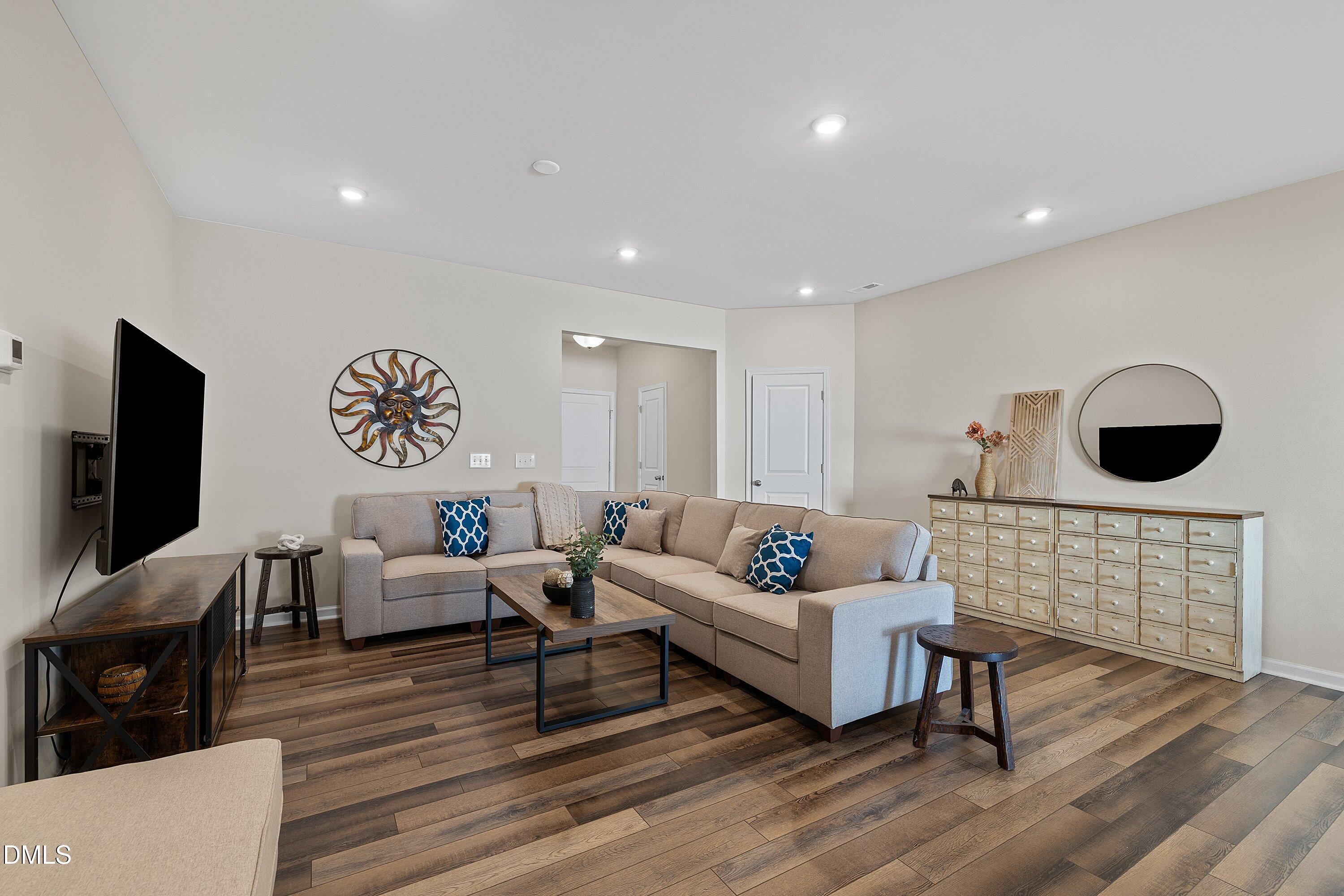 1004 Everglades Way Durham, NC 27713 - Photo 10 of 40 a living room with furniture and a flat screen tv