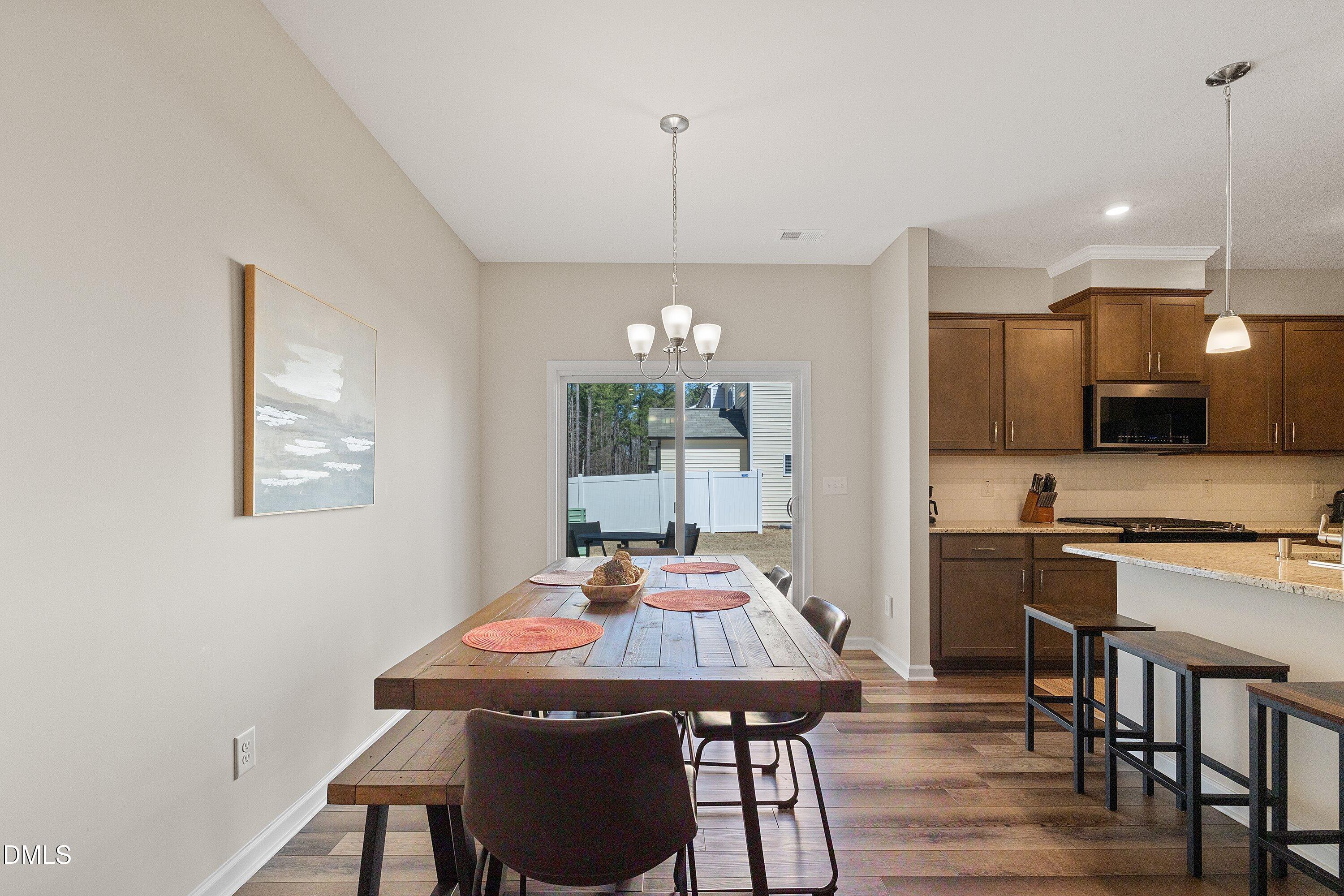 1004 Everglades Way Durham, NC 27713 - Photo 12 of 40 a view of a dining room with furniture window and wooden floor