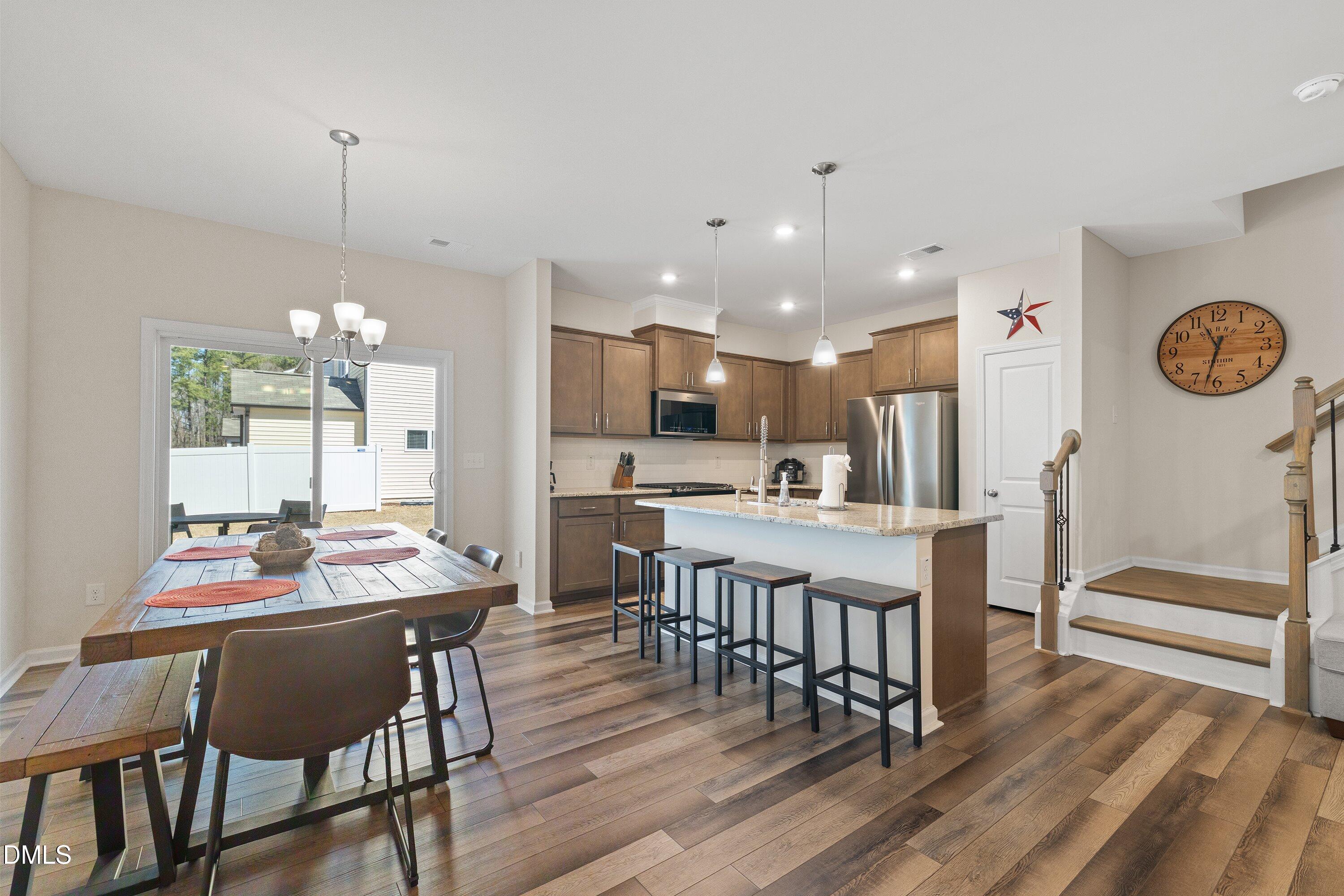 1004 Everglades Way Durham, NC 27713 - Photo 13 of 40 a dining room with furniture and wooden floor