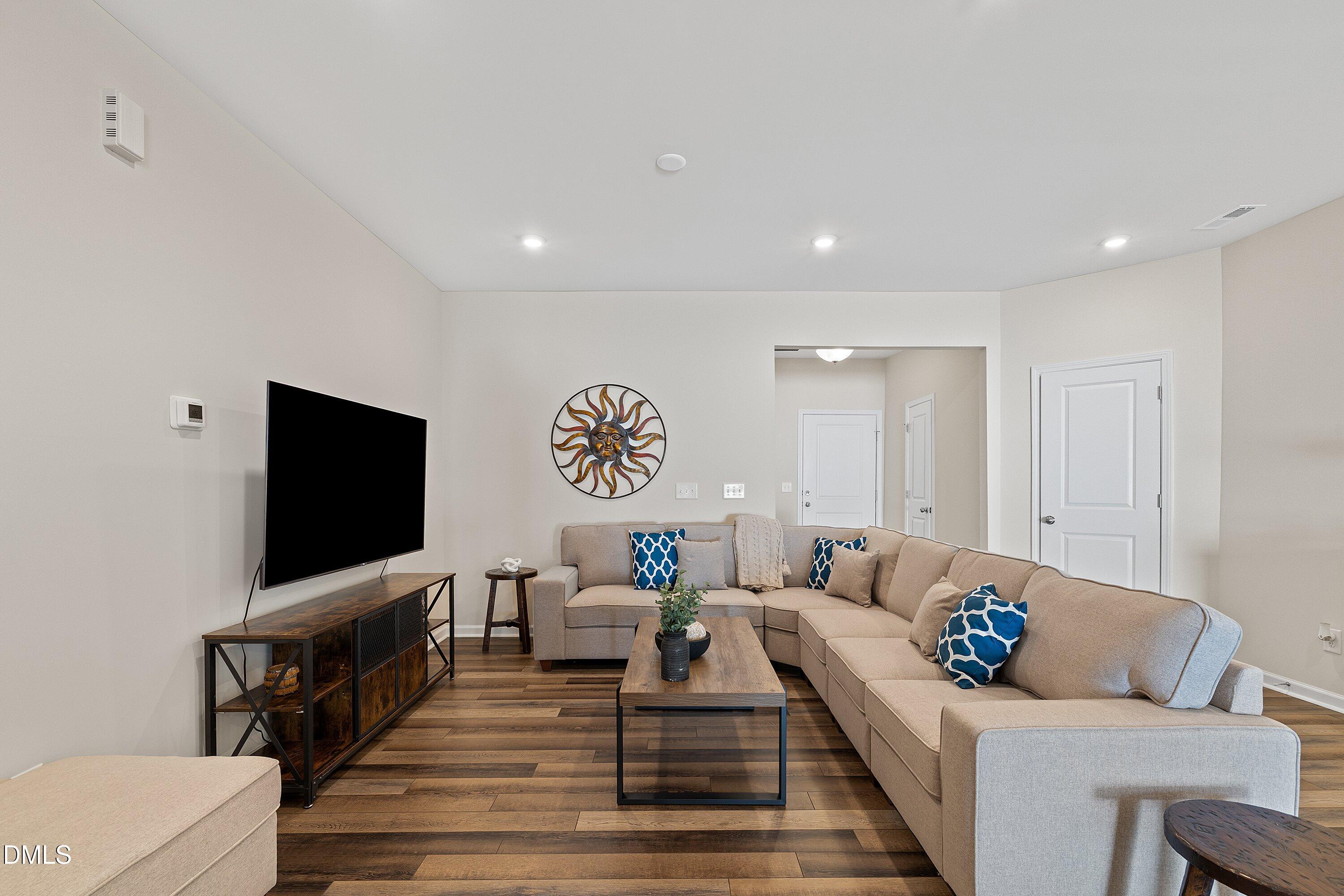 1004 Everglades Way Durham, NC 27713 - Photo 20 of 40 a living room with furniture and a flat screen tv