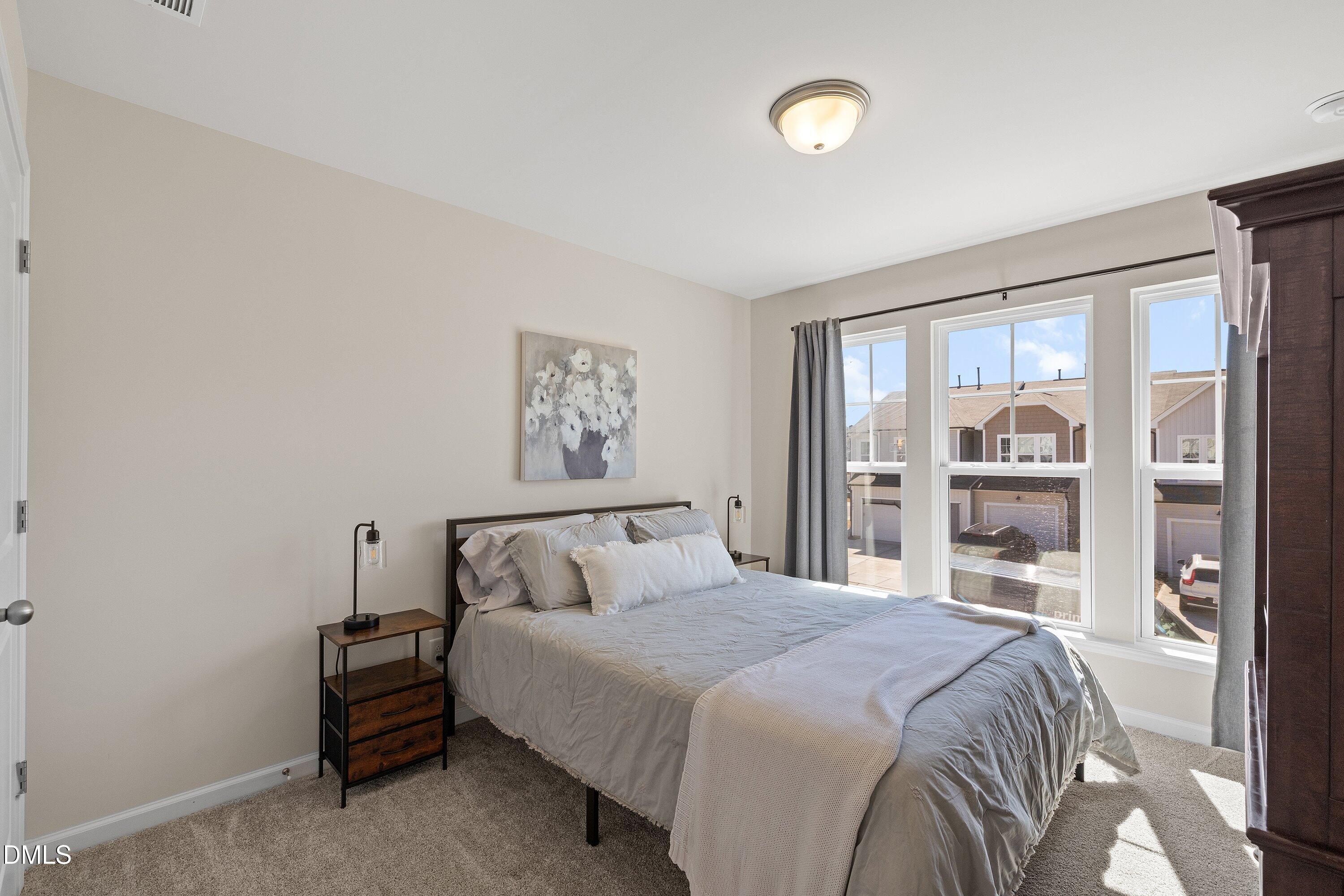 1004 Everglades Way Durham, NC 27713 - Photo 23 of 40 a bedroom with a large bed and a window