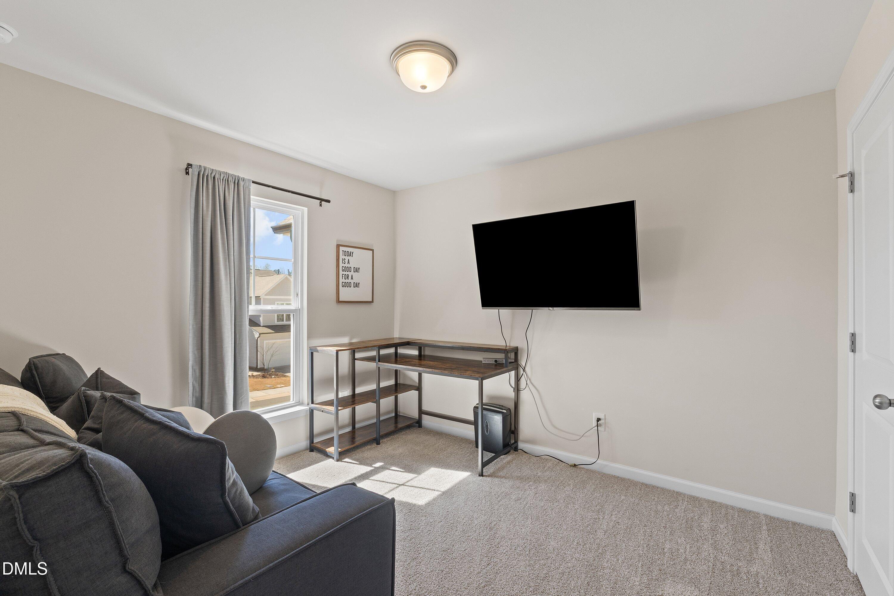 1004 Everglades Way Durham, NC 27713 - Photo 25 of 40 a living room with furniture and a flat screen tv