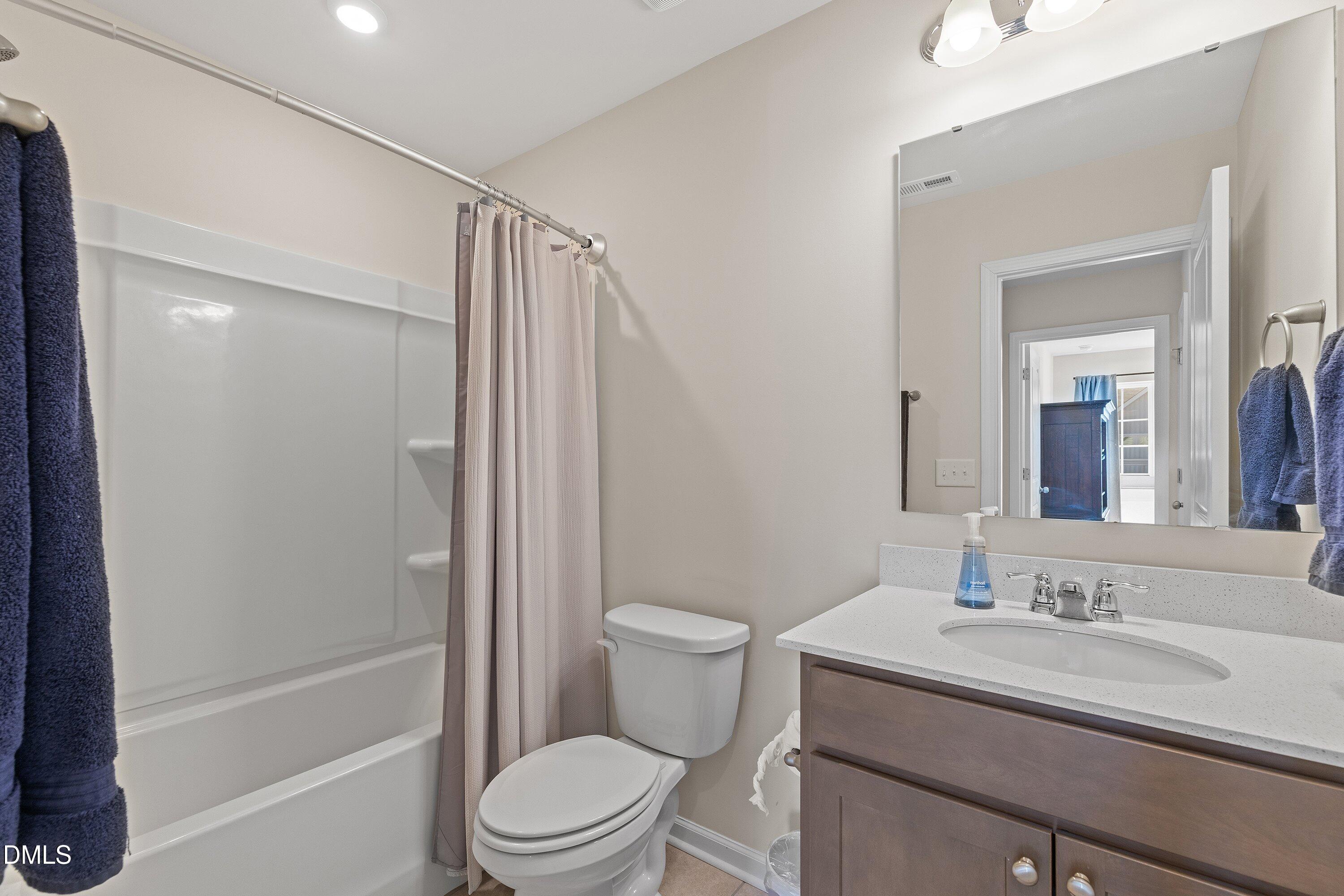 1004 Everglades Way Durham, NC 27713 - Photo 27 of 40 a bathroom with a granite countertop sink toilet and shower