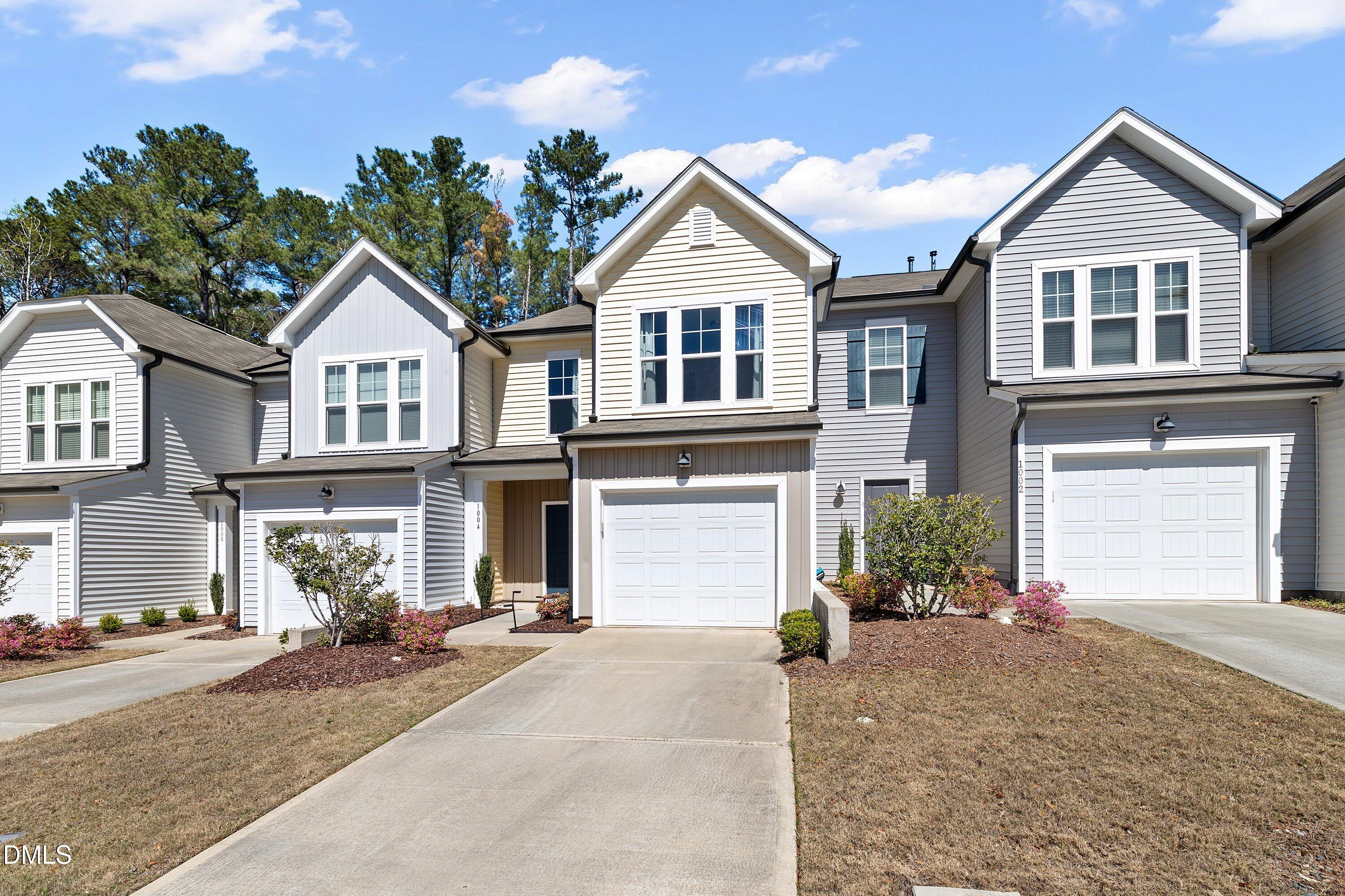 1004 Everglades Way Durham, NC 27713 - Photo 2 of 40 a front view of a house with a yard and garage