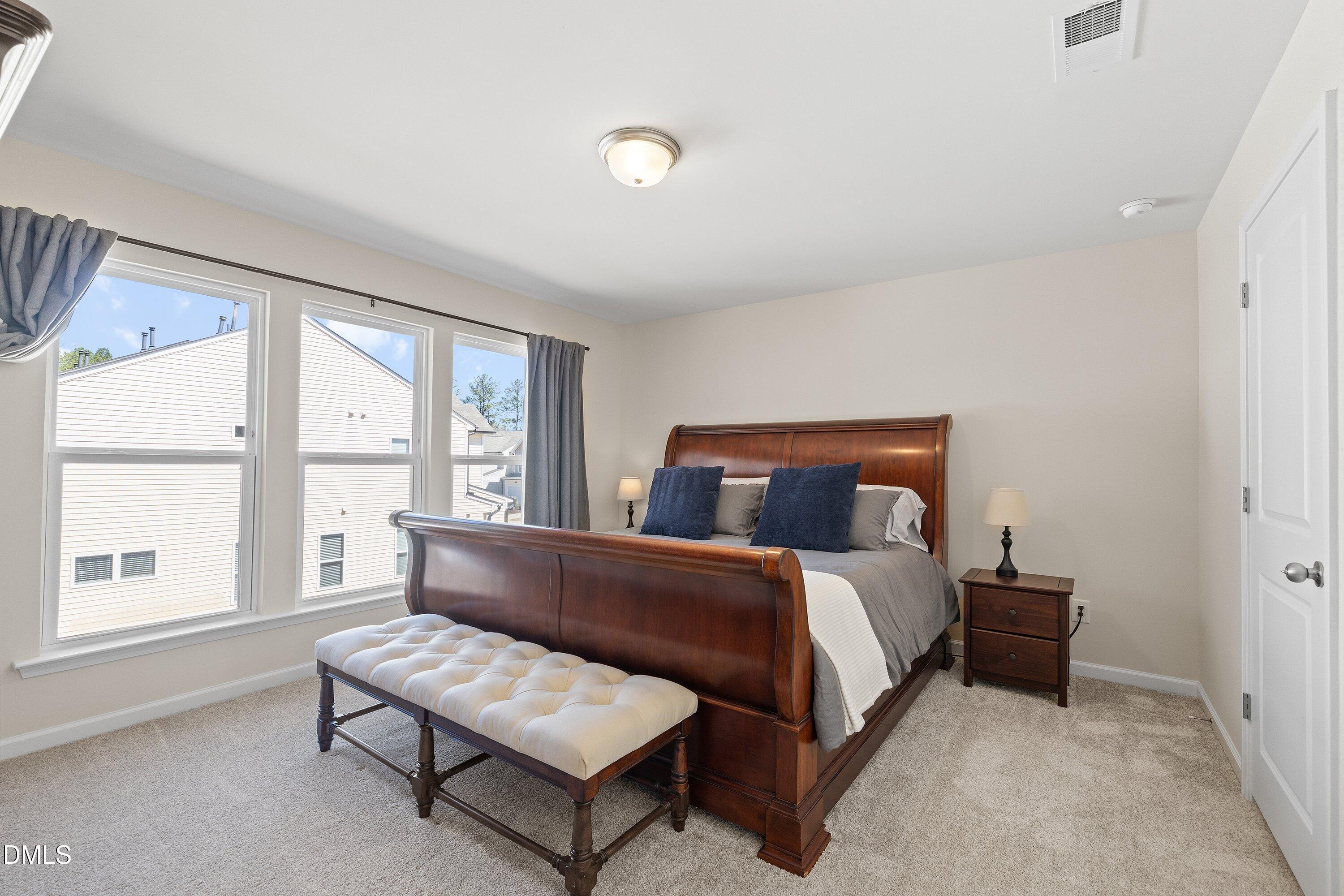 1004 Everglades Way Durham, NC 27713 - Photo 31 of 40 a bedroom with a bed and a large window
