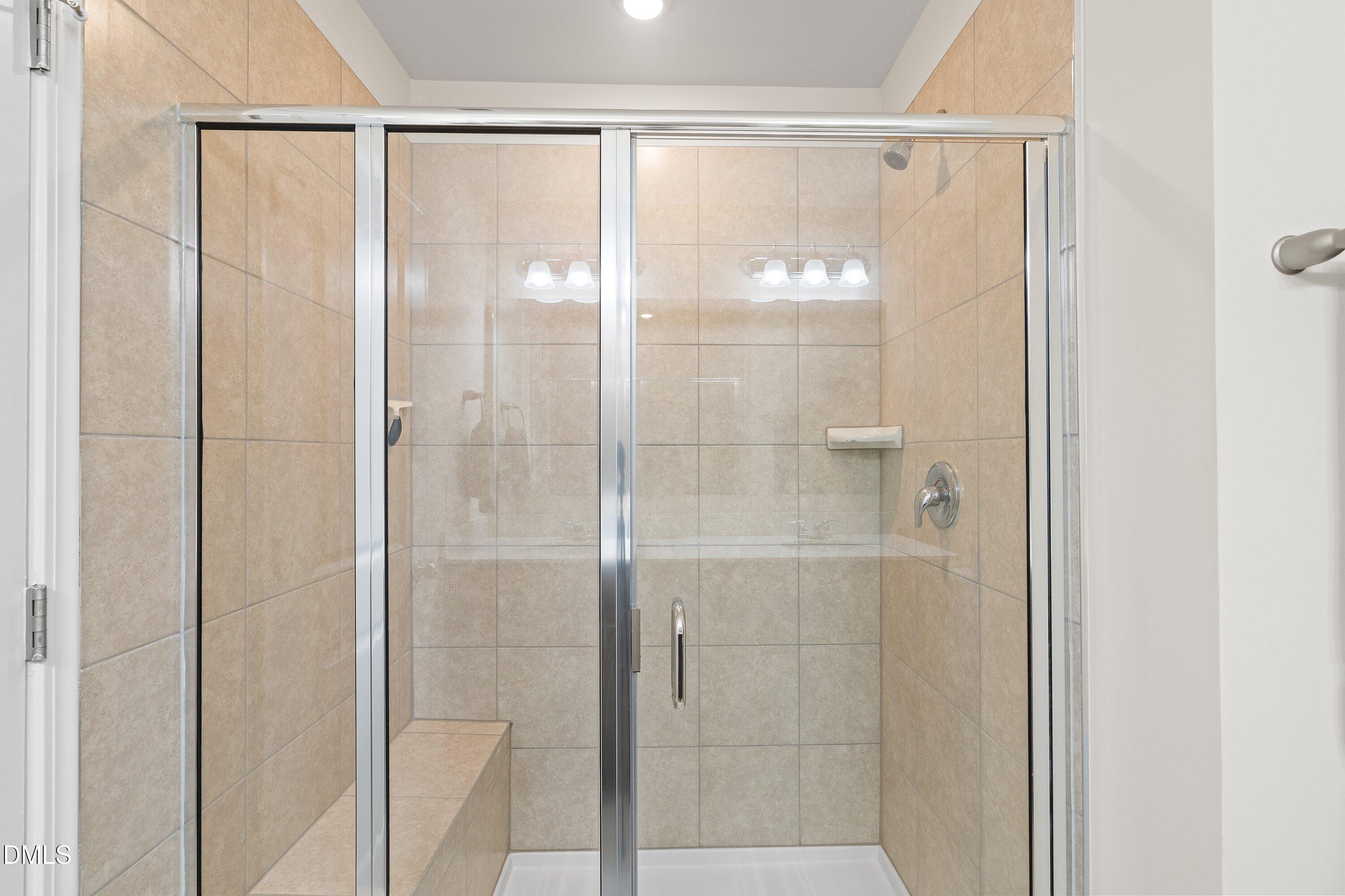 1004 Everglades Way Durham, NC 27713 - Photo 36 of 40 a bathroom with a glass shower door