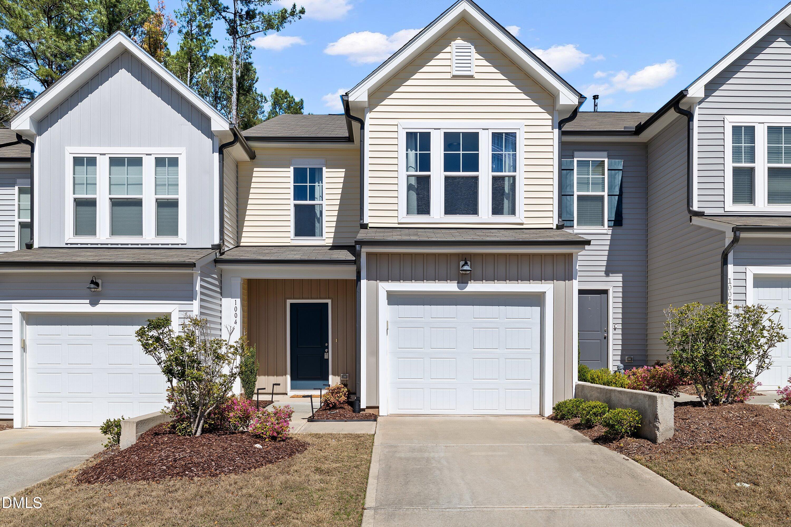 1004 Everglades Way Durham, NC 27713 - Photo 3 of 40 a front view of a house with a yard and garage
