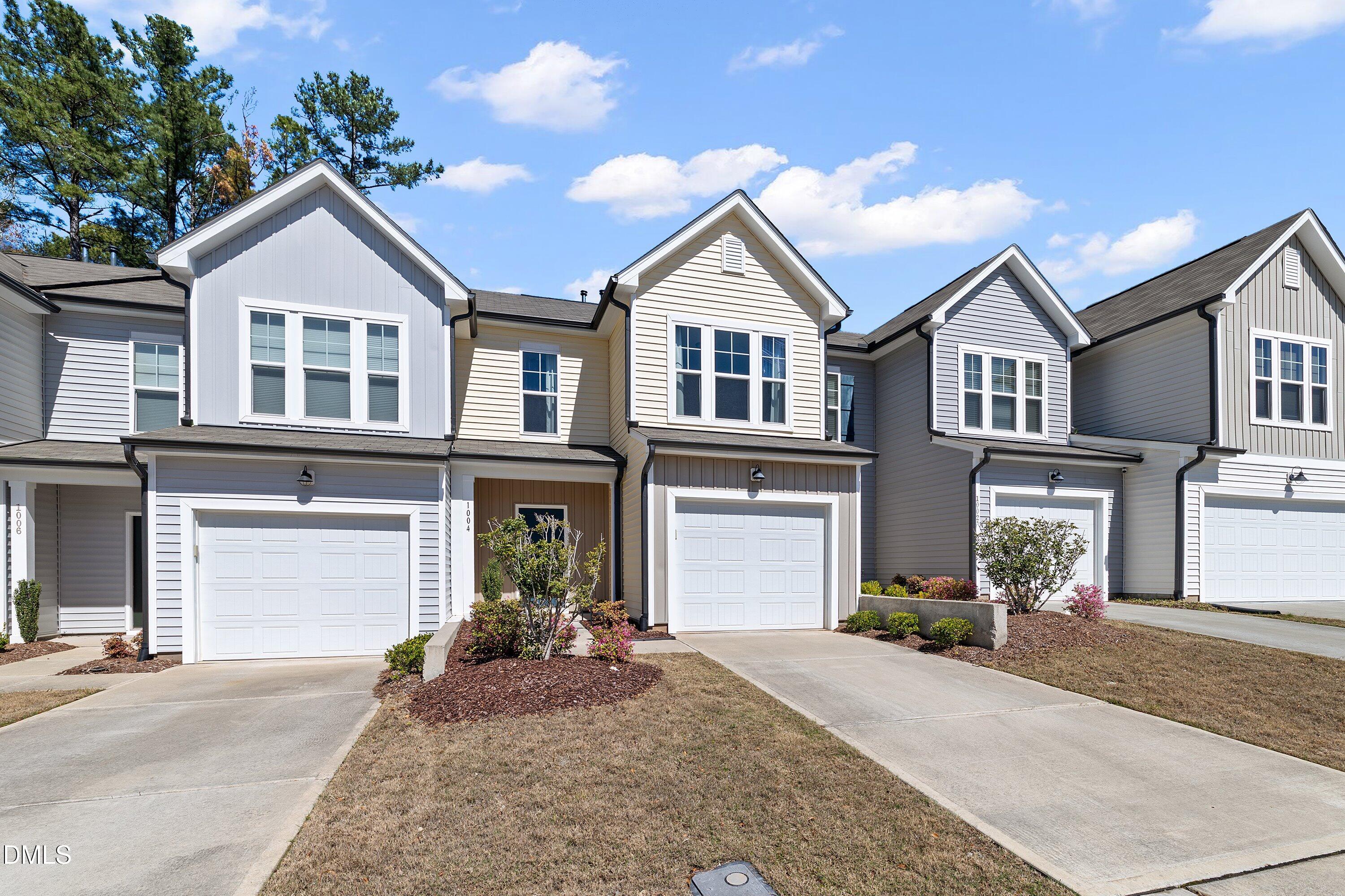 1004 Everglades Way Durham, NC 27713 - Photo 4 of 40 a front view of a house with a yard and garage