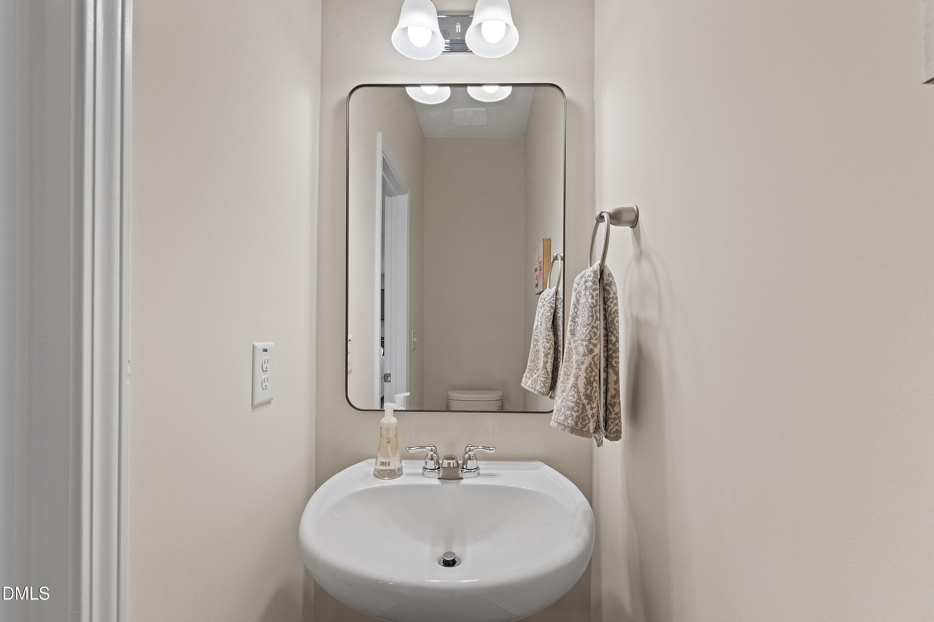 1004 Everglades Way Durham, NC 27713 - Photo 8 of 40 a bathroom with a sink and a mirror