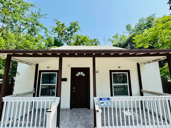 a side view of a house with a small porch
