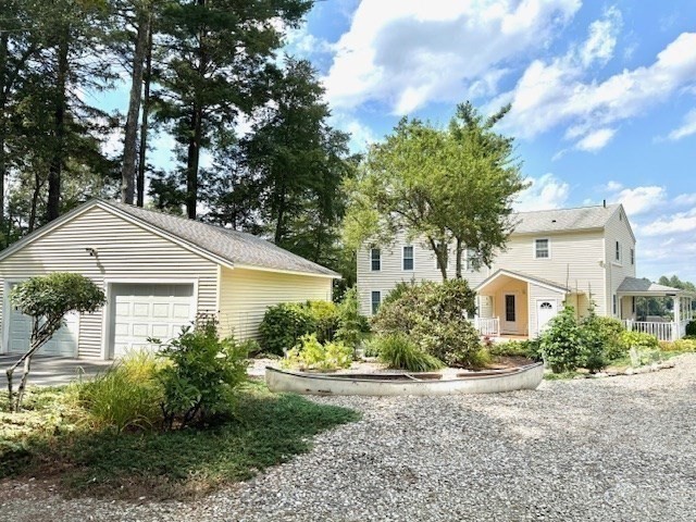 31 Bay View Road Webster, MA 01570 - Photo 3 of 42 a front view of a house with a yard and garage