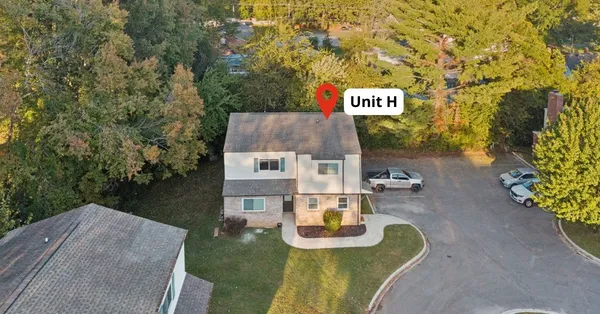 a wooden bench sitting in front of a building