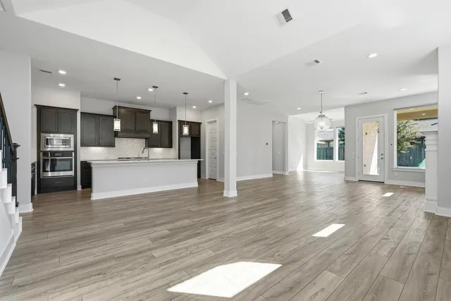 a spacious bathroom with a double vanity sink mirror and shower