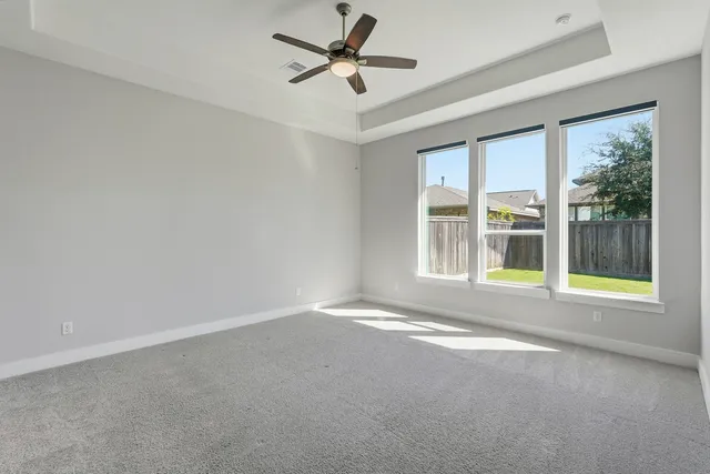 an aerial view of residential houses with outdoor space and lake view