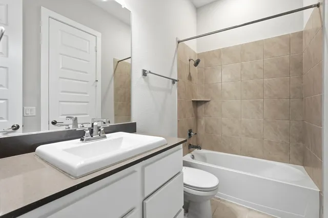 a view of a room with wooden floor fireplace and windows