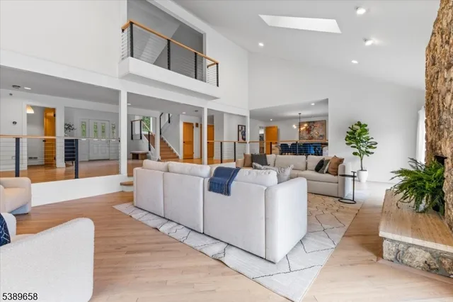 a living room with furniture and a dining table with kitchen view