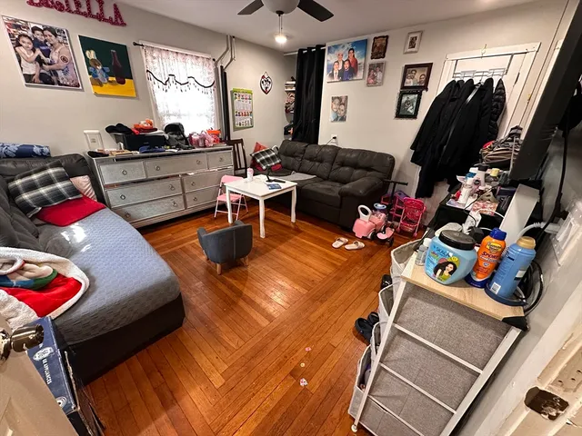 a living room filled with furniture and a flat screen tv