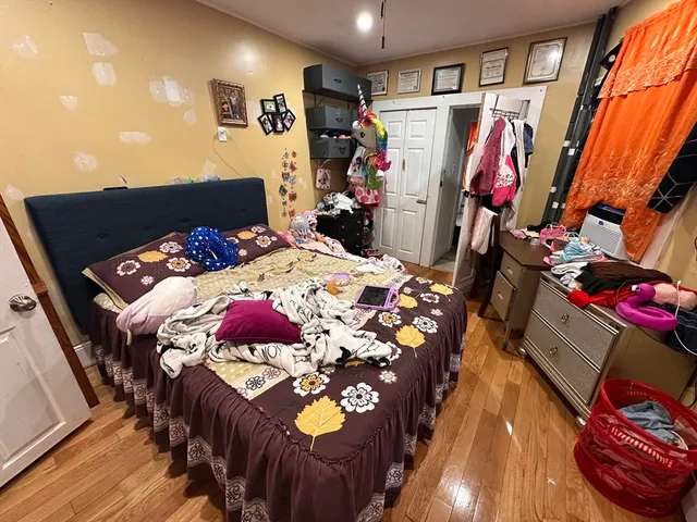 a bed sitting in a bedroom next to a window