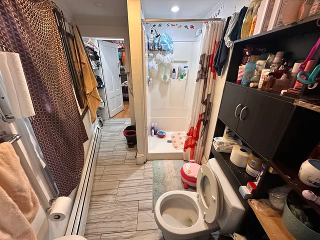 a bathroom with a sink a toilet and shower curtain