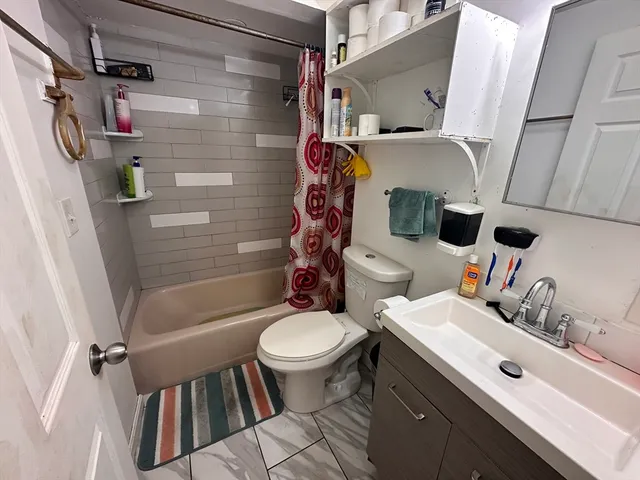 a living room with furniture a flat screen tv and a sink