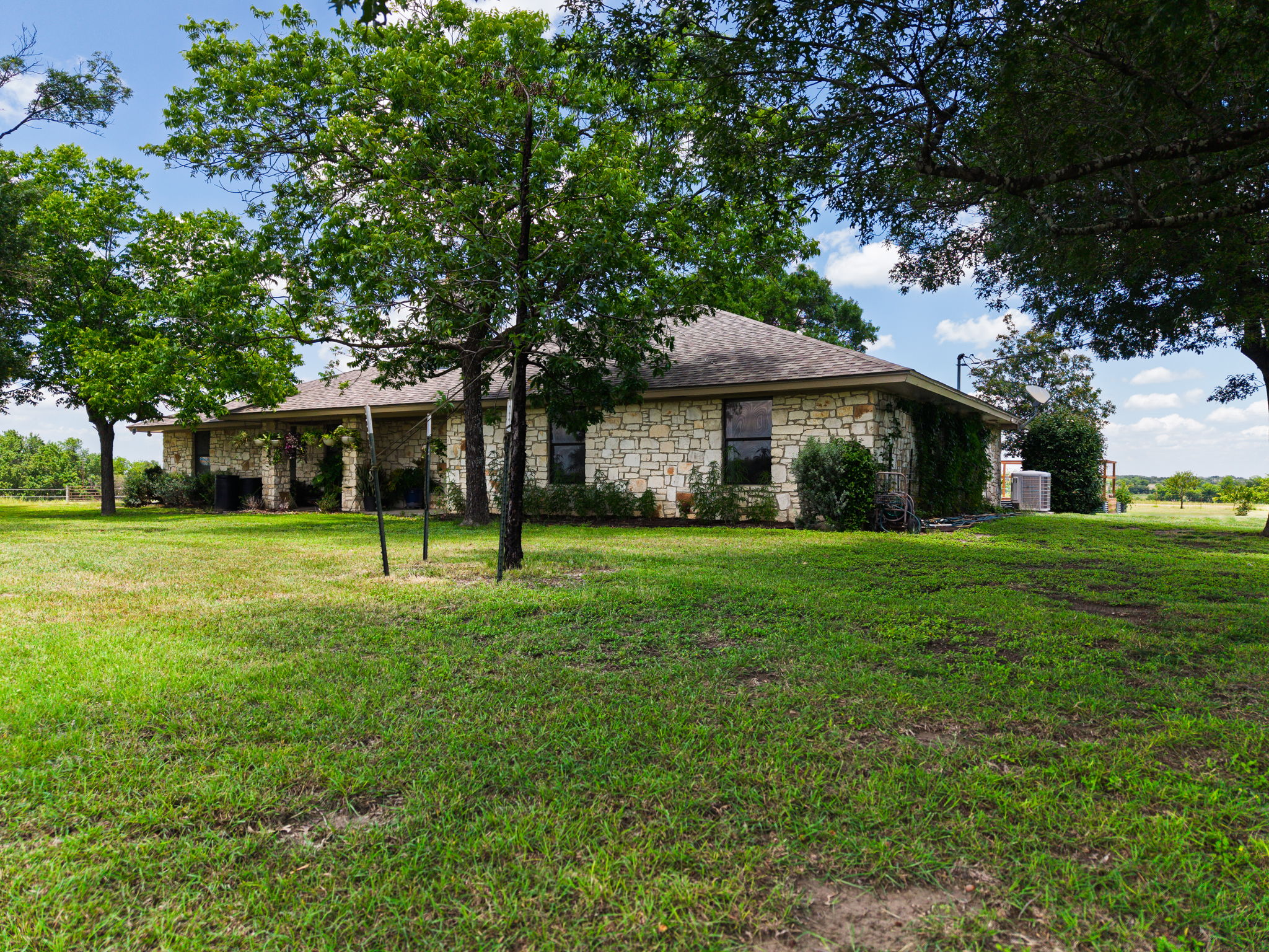 120 Rae Lane Jarrell, TX 76537 - Photo 3 of 40 Stone-clad exterior featuring multiple windows and a covered patio