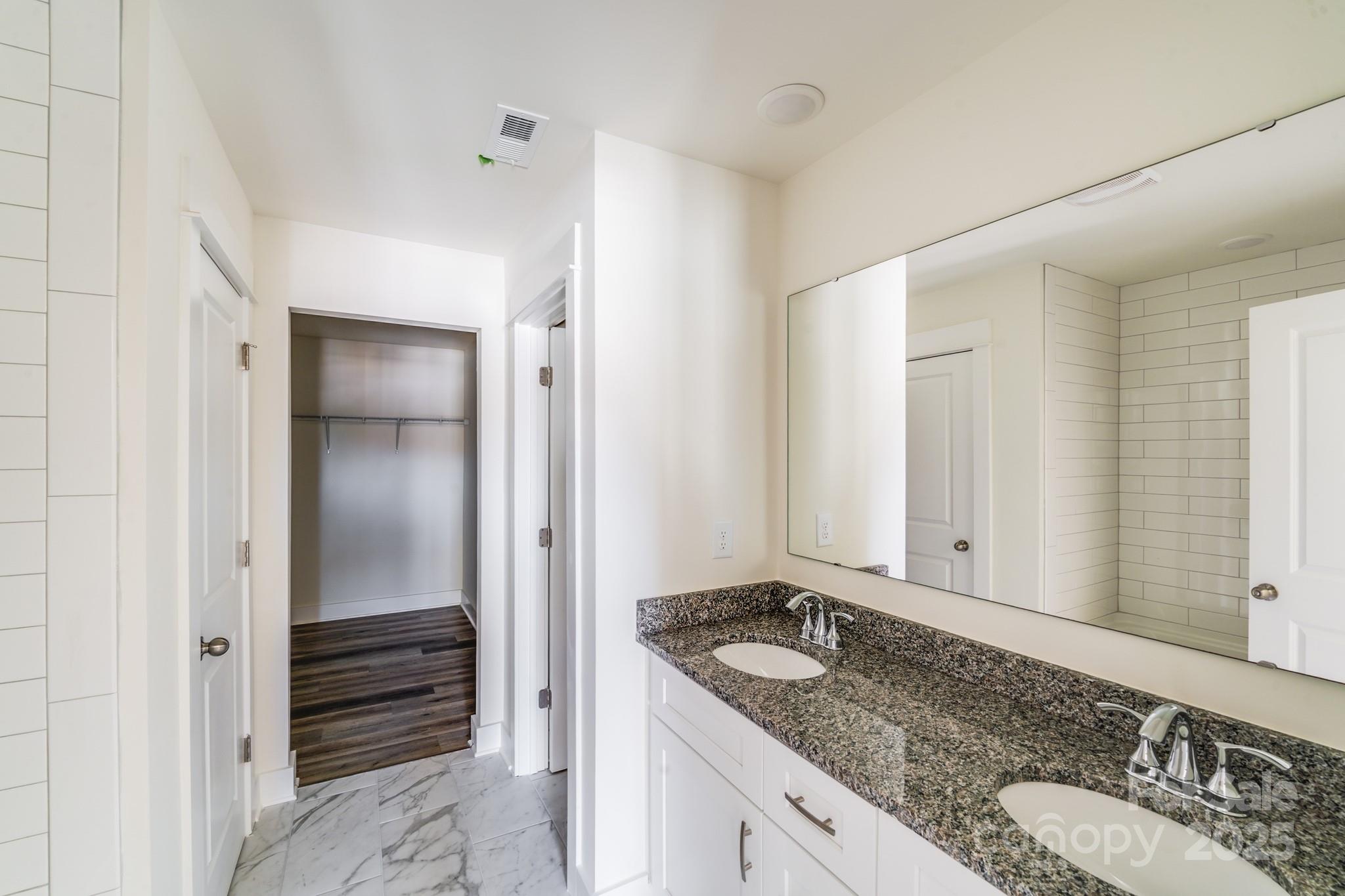 212 Sugar Hill Road Troutman, NC 28166 - Photo 40 of 47 a bathroom with a granite countertop sink and a mirror