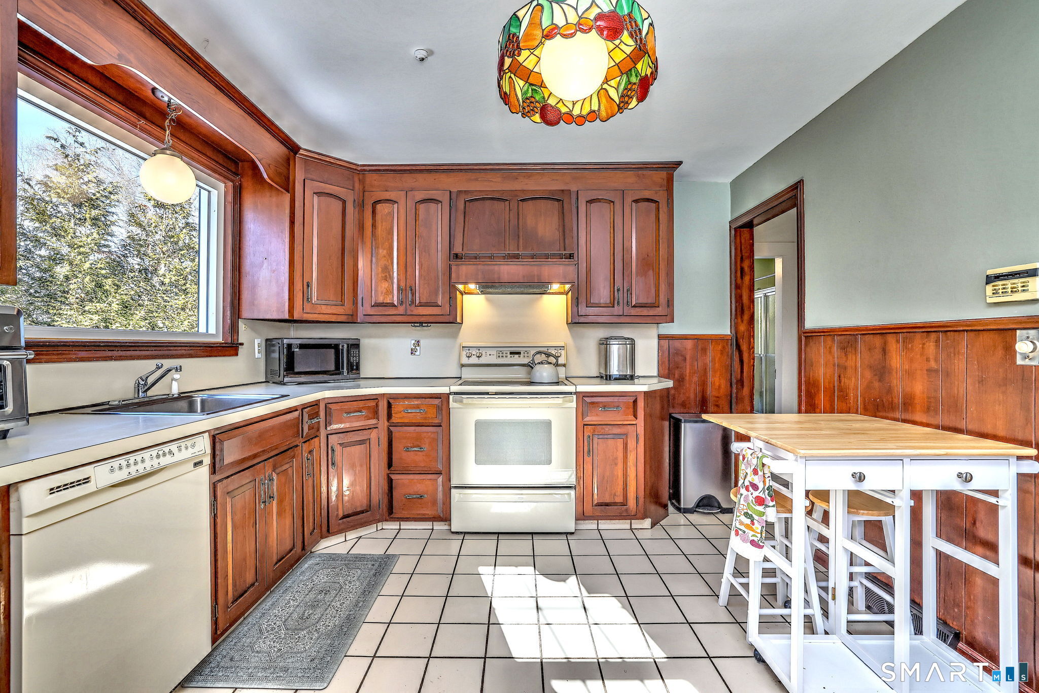 3 Wheeler Drive Trumbull, CT 06611 - Photo 26 of 32 a kitchen with a stove a sink and a microwave