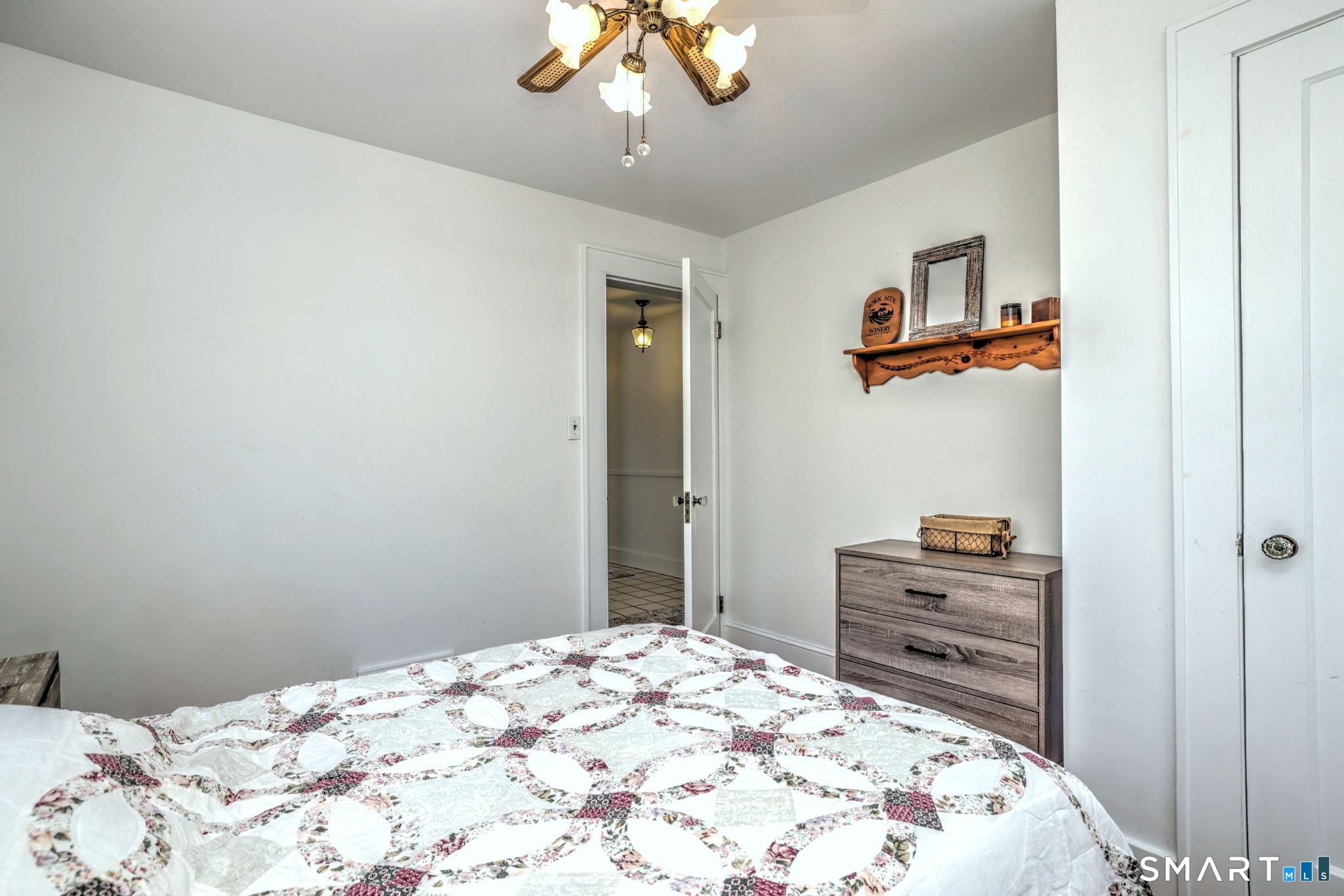 3 Wheeler Drive Trumbull, CT 06611 - Photo 29 of 32 a bedroom with a bed and a chandelier