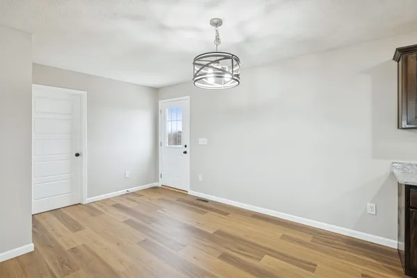 a view of a room with wooden floor and a window