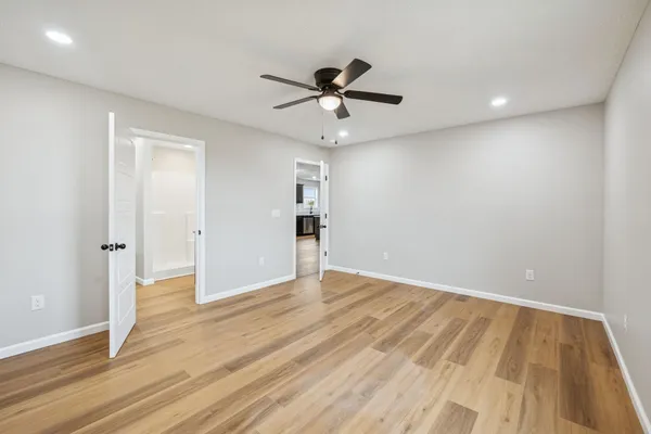 a view of an empty room with wooden floor