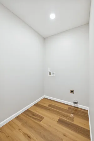 a view of a room with wooden floor