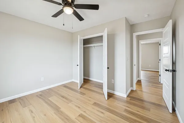 a view of empty room with wooden floor