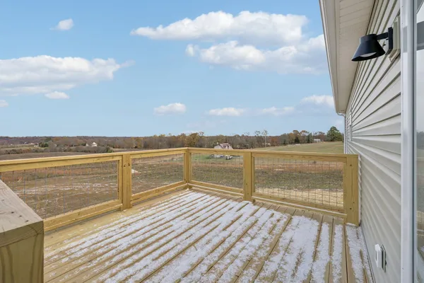a view of a balcony with wooden floor