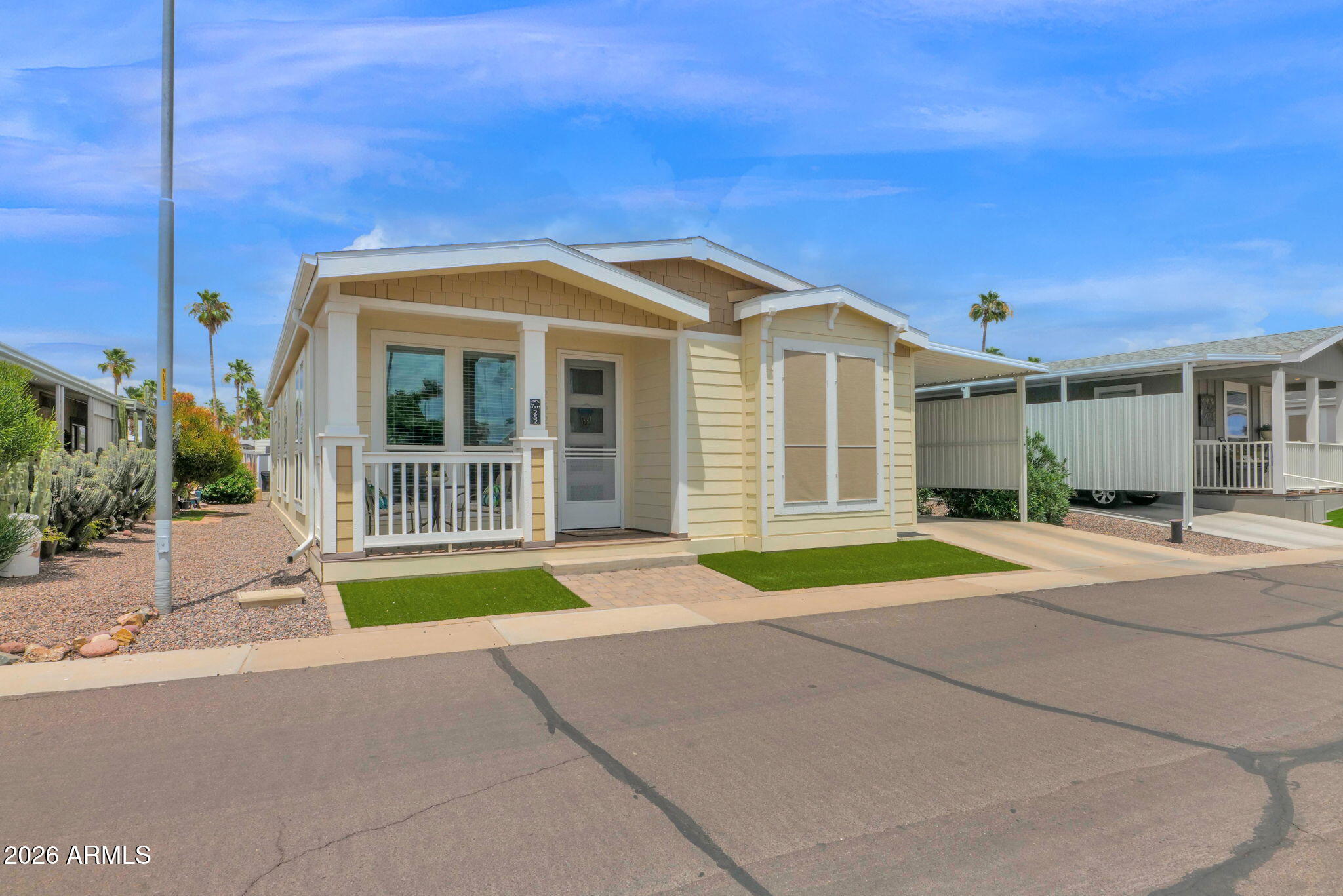 3300 East Broadway Road, Unit 252 Mesa, AZ 85204 - Photo 2 of 35 a front view of a house with a yard and garage