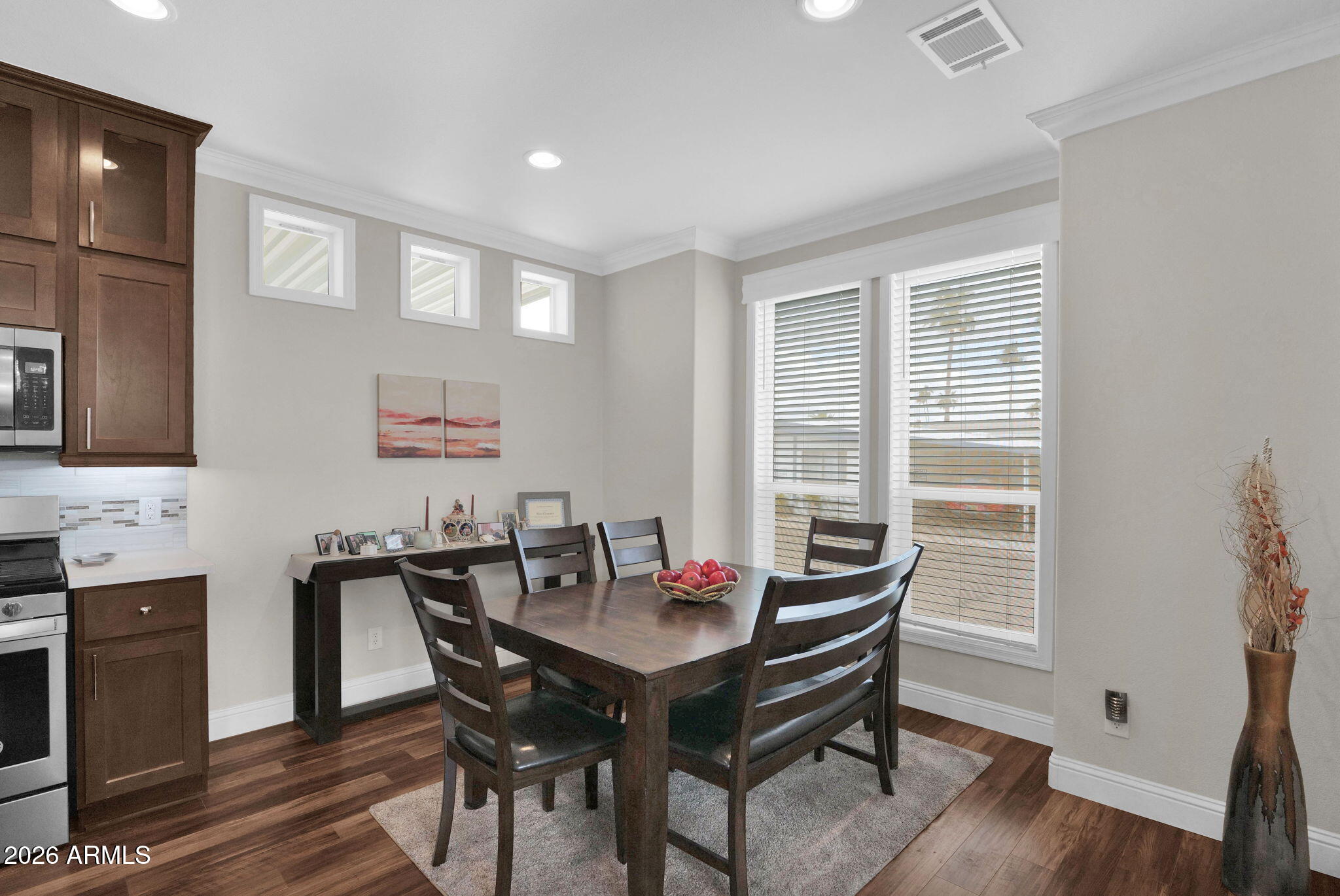 3300 East Broadway Road, Unit 252 Mesa, AZ 85204 - Photo 22 of 35 a view of a dining room with furniture window and wooden floor
