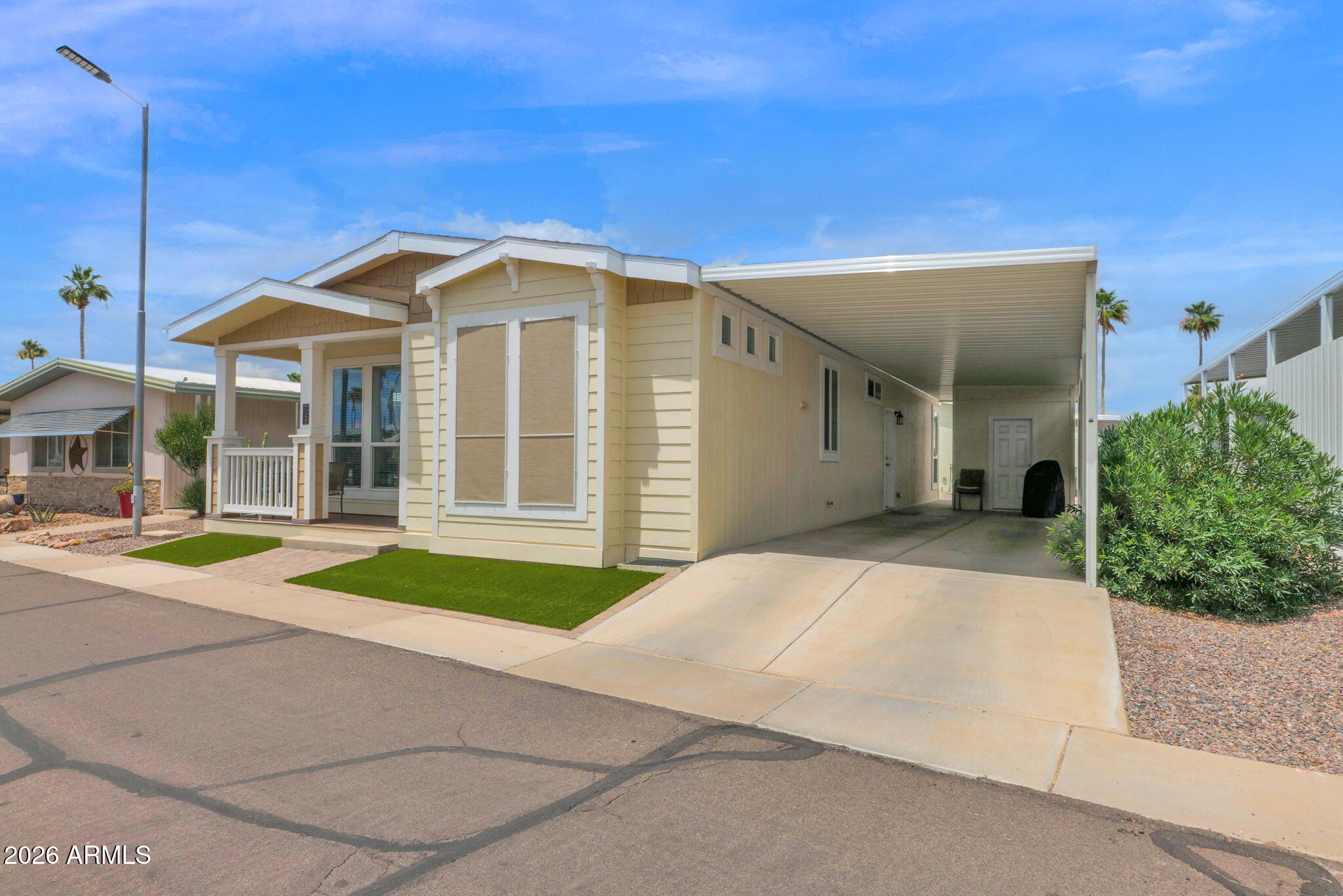 3300 East Broadway Road, Unit 252 Mesa, AZ 85204 - Photo 3 of 35 a front view of a house with a yard