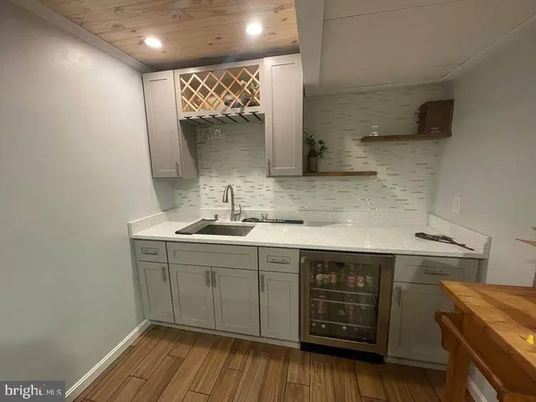 a kitchen with a sink cabinets and wooden floor