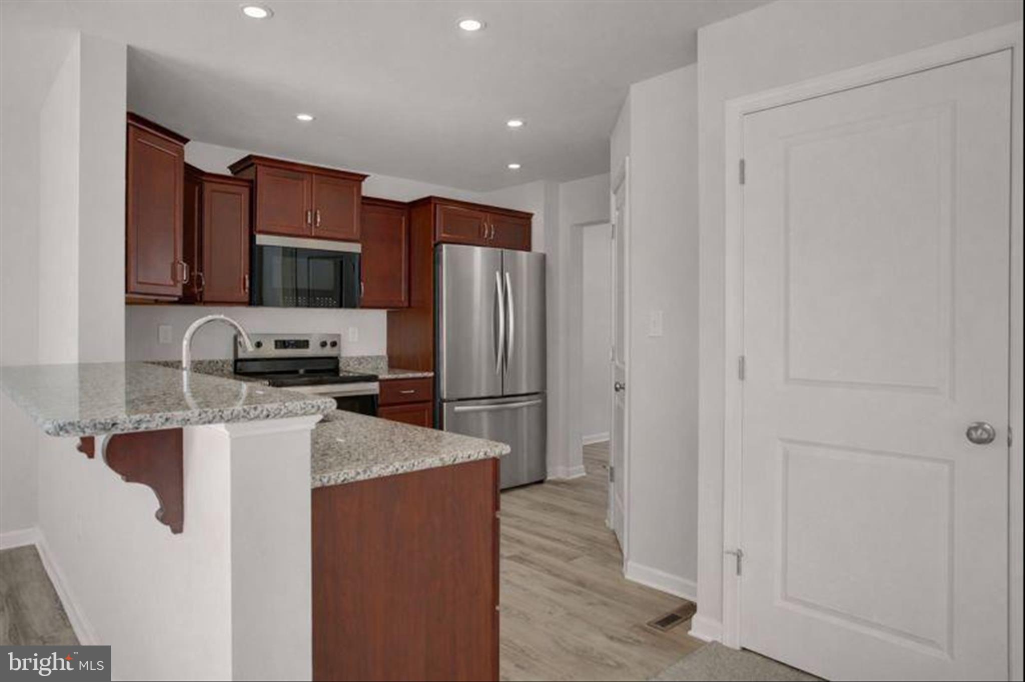 601 Exeter Lane Shippensburg, PA 17257 - Photo 14 of 48 a kitchen with stainless steel appliances granite countertop a refrigerator a stove a sink and a microwave