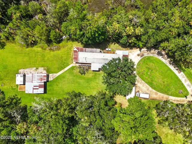 an aerial view of a house with a yard swimming pool outdoor seating and yard