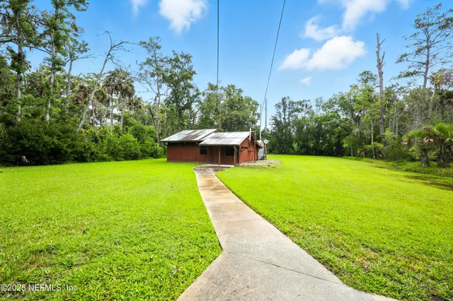 a view of a swimming pool with a yard